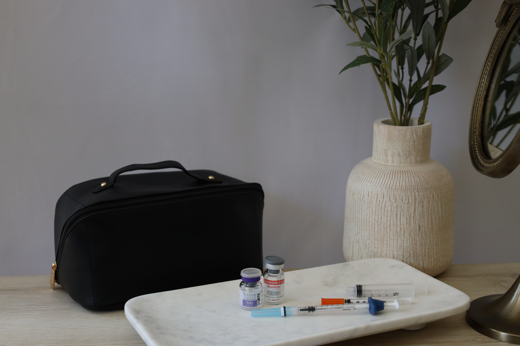 RN Concierge treatment kit with Botox, Jeuveau, and treatment supplies arranged on a marble tray